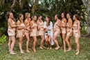 Getting ready with bridal party and champagne pop in boho pajamas