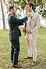 Boho, mismatch bridesmaids, groomsmen in green suits, light beige groom suit, boho fringe bride - boho bridal party