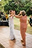 Surprise dance with mom and boho bride in fringe dress at wedding