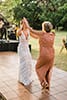 Surprise dance with mom and boho bride in fringe dress at wedding